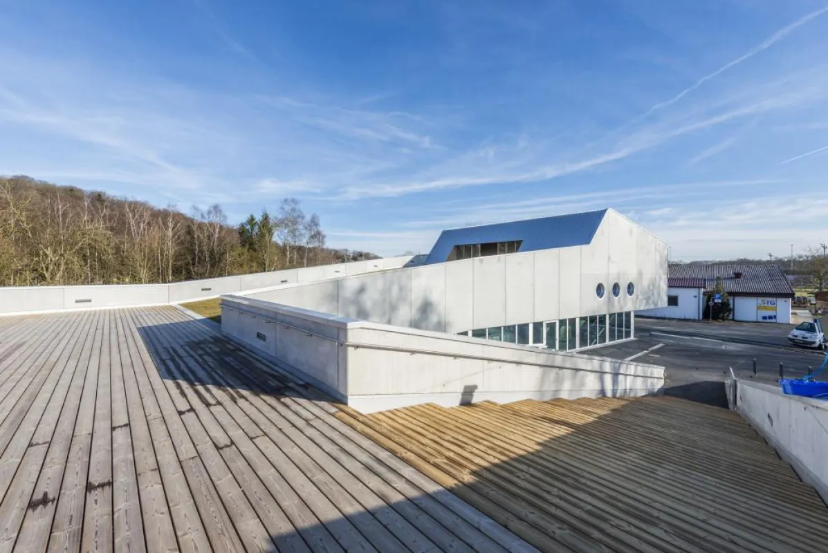 Der gedrehte Außenaufgang führt barrierefrei auf das Dach des Jugendhauses.