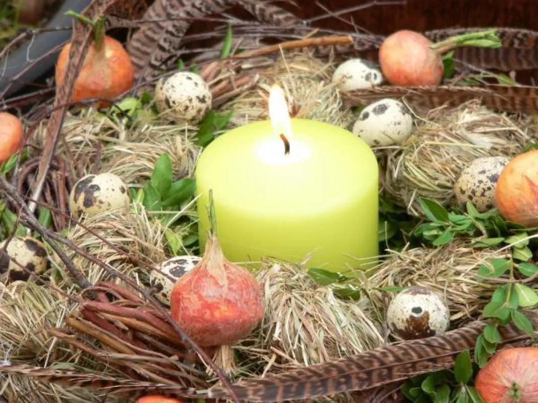 Ein tolles Osternest bei dem in der Mitte eine leuchtend grüne Stumpenkerze sanftes Licht versprüht! Foto: Gütegemeinschaft Kerzen
