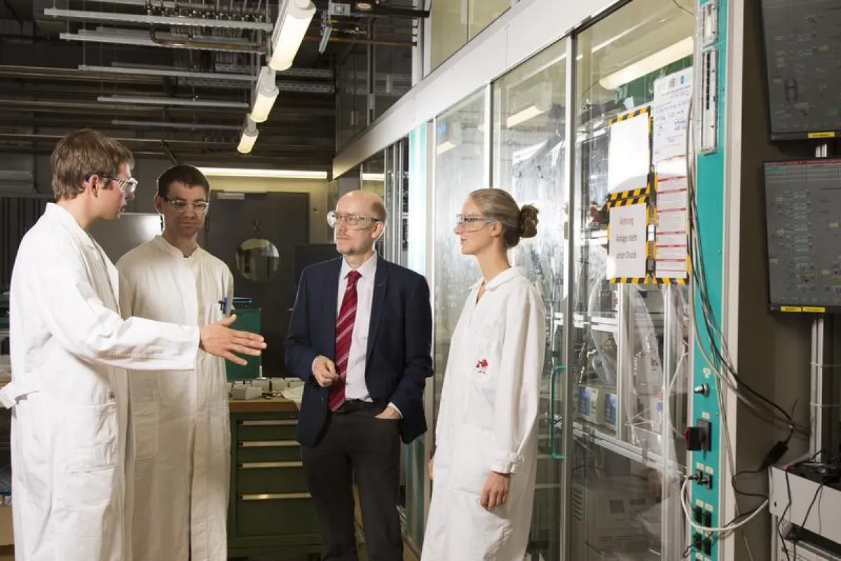 Jens Dreimann, Michael Jokiel, Prof. Dr. Kai Sundmacher und Stefanie Markstein (v.li.) besprechen am Versuchsreaktor die letzten Details vor dessen Überführung nach Dortmund. (Foto: Harald Krieg/Unive