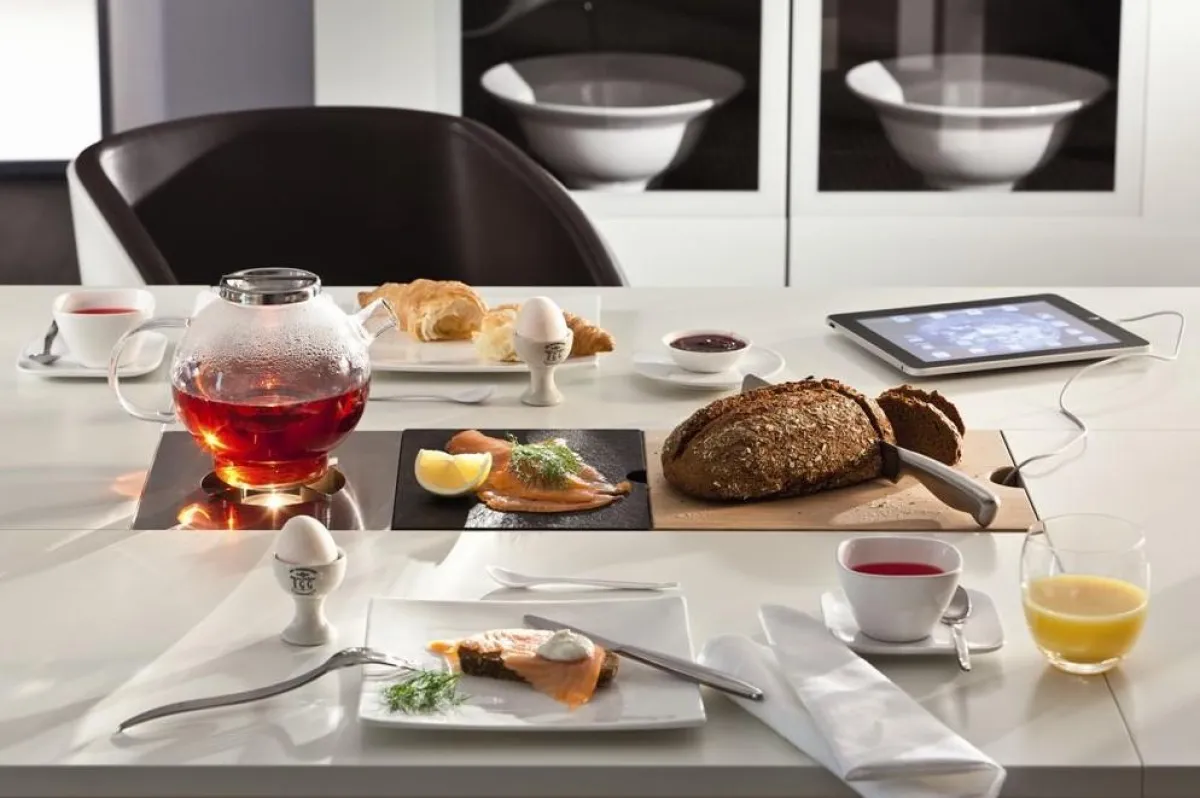 Wandelbar durch verschiedene Funktionseinsätze: Hier mit Stövchen, Granitplatte und Schneidebrett.