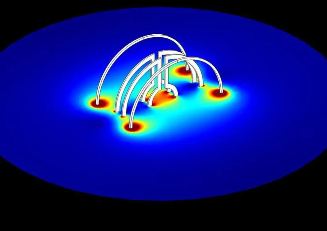 Zwei Lenz-Linsen in einem Helmholtz-Spulenpaar angeordnet. Die Simulation zeigt, wie die Lenz-Linsen den magnetischen Fluss räumlich fokussieren. ( (Abbildung: Nils Spengler/KIT) )