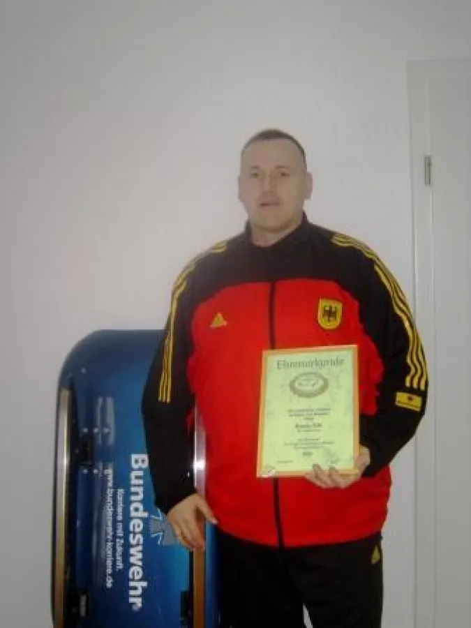 Hauptfeldwebel Ronny Elle mit seinem Rennrodel und der Ehrenurkunde