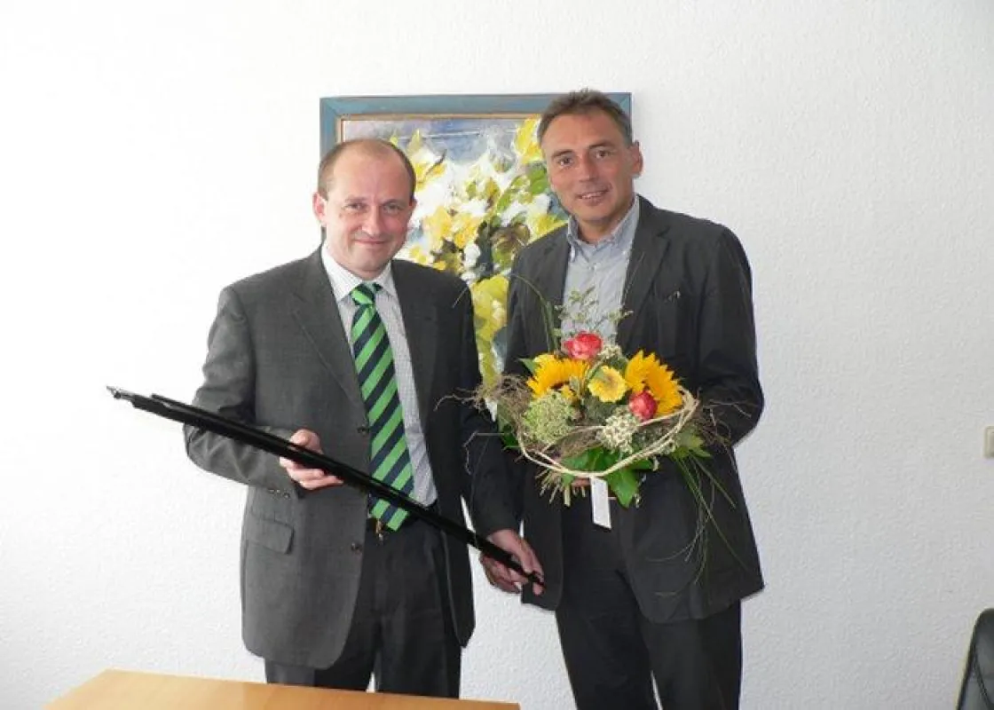 v.l.n.r. Daniel Trutwin, Geschäftsführer der MWG Unternehmensgruppe, übergibt symbolisch ein Element zur Herstellung eines Dachfensters an Oberbürgermeister Peter Gaffert