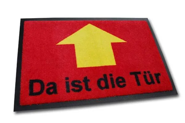 Bild: Richtungsweisend: Fussmatte «Da ist die Tür» bei geschenkbox.de
