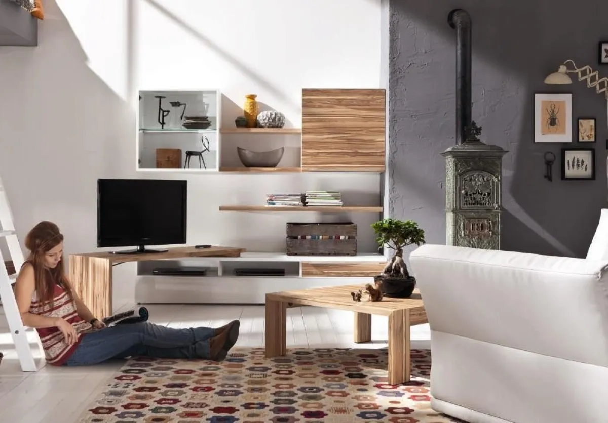 Eine TV-Bank lässt sich raumsparend an die Wand schwenken. Low- und Wandboards bieten viel Stauraum.