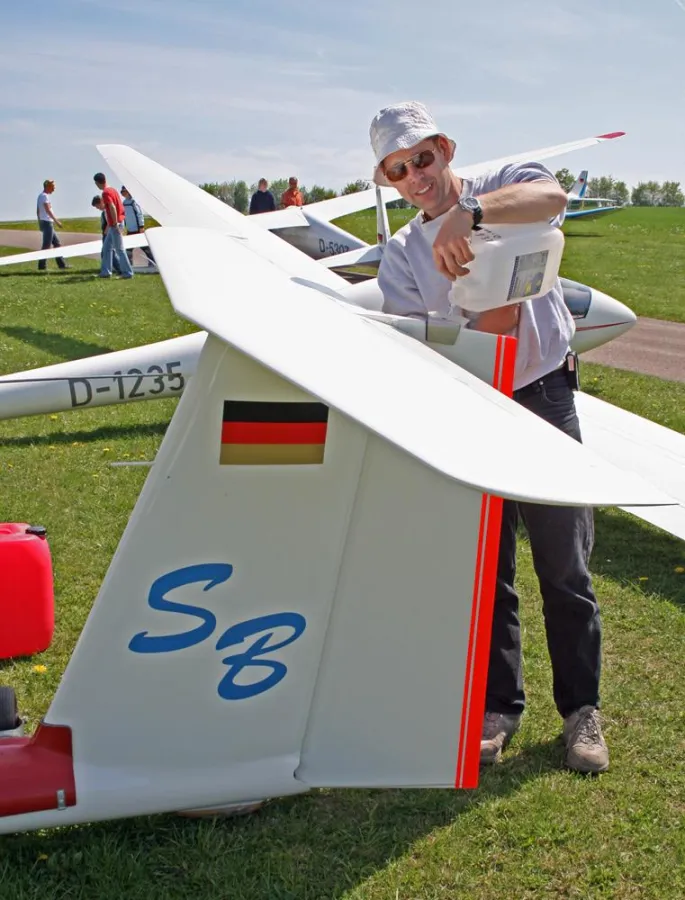 Segelflugpilot Stephan Bosch befüllt das Heck seines Seglers mit Wasser, um den Schwerpunkt optimal einzustellen.