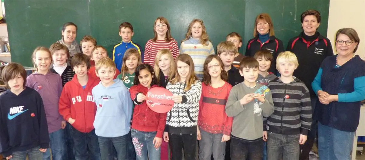 Die Kinder der Grundschule Lesse präsentieren ihre Forscherplakette der AWO Junioruniversität in Gegenwart Ihrer Lehrerin Christiane Stamm (hinten links), dem Dozententeam Jennifer Wimmer und Kornelia