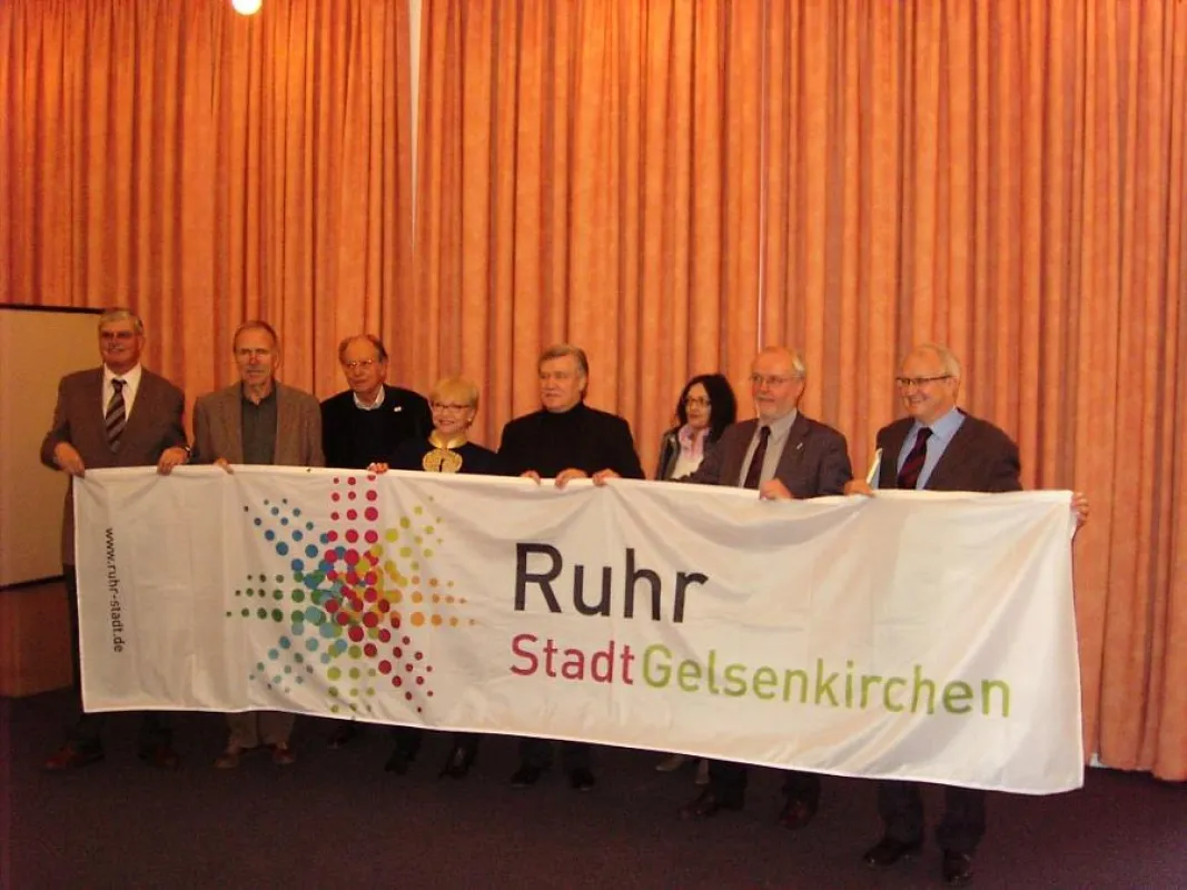 Peter Krämer (5.v.l.) überreichte die Ruhrstadt Fahne im Gelsenkirchener Rathaus