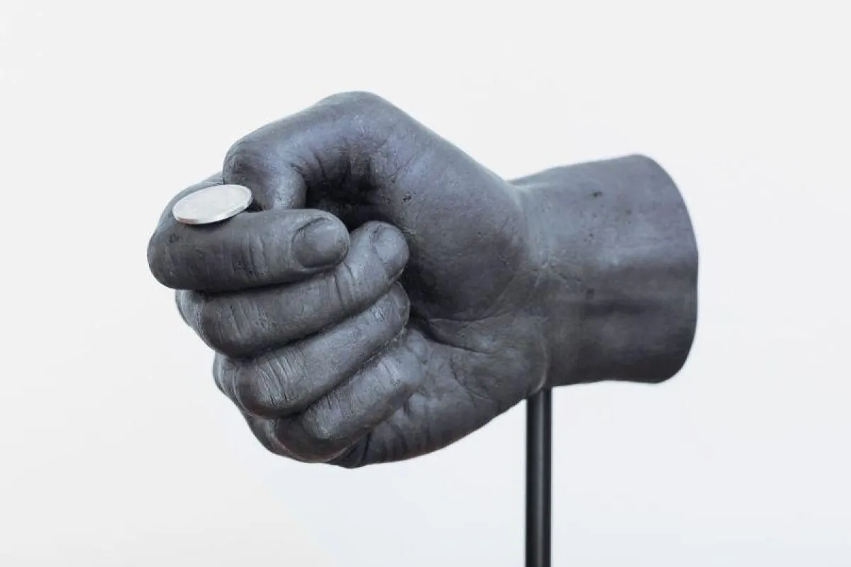 2012 entstand diese Bronzehand, die im Begriff ist eine Münze zu werfen.