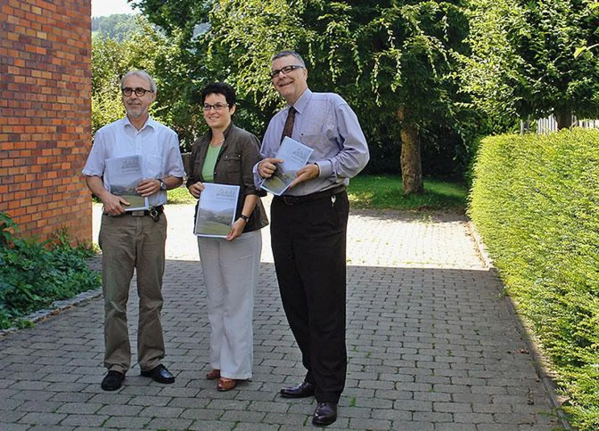 Bürgermeister Eugen Jehle (links) und Andrea Würzburger (Mitte) halten das taufrische Leitbild in den Händen.