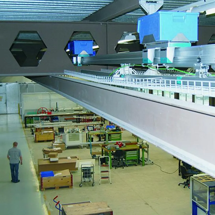 Eine Montrac-Anlage transportiert Komponenten vom Kommisssionierbereich in die Montage. Das System ist unter dem Hallendach angebracht, um Fußboden frei zu halten.