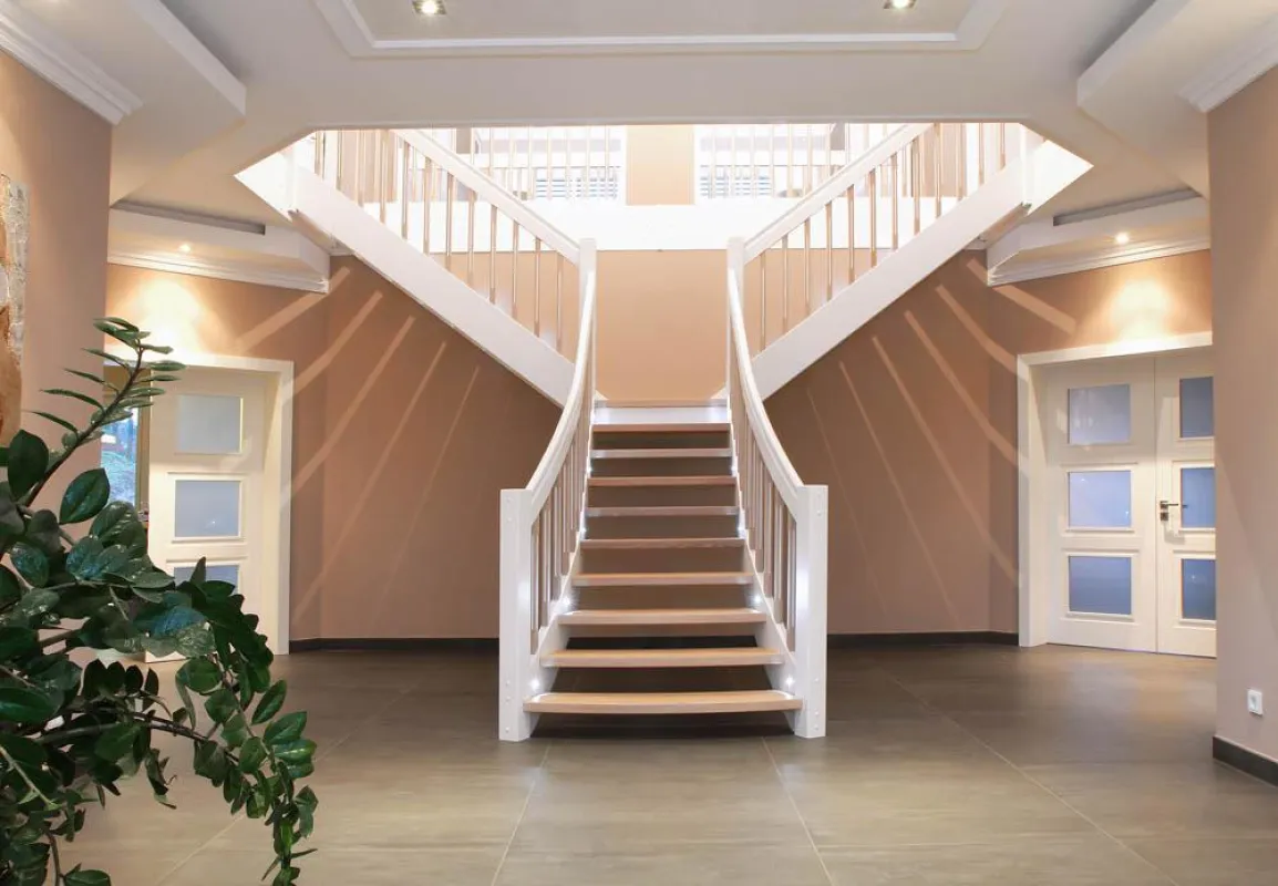 Die STREGER-Treppe in T-Form ist eine stilgerechte Lösung für großzügige Eingangsbereiche.