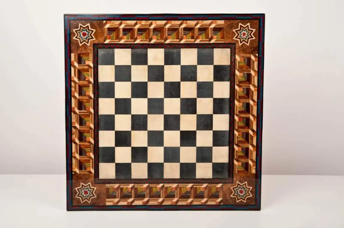 Das Schachbrett mit Feldern in schwarzem und cremefarbenen Rochenleder und mit von Hand eingelegten Holzintarsien.