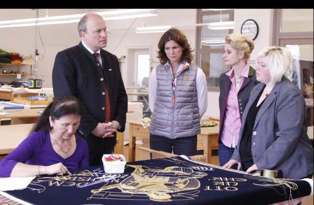 Landrätin Tanja Schweiger und Bürgermeister Christian Kiendl in der Stickerei von Fahnen Kössnger