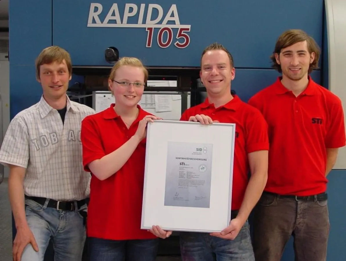 PSO-Urkunde der STI Schräder bei M. Sniegon (Leitung Druckerei), S. Wöste (Vorstufe), W. Rupp und F. Niehoff (Drucker) (v.l.)