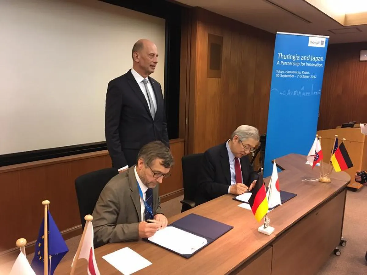 FSU-Präsident Prof. Dr. Walter Rosenthal (v.l.) und JAXA-Generaldirektor Dr. Saku Tsuneta (v.r.) unterzeichnen im Beisein von Thüringens Wissenschaftsminister Wolfgang Tiefensee die Vereinbarung. (Fot
