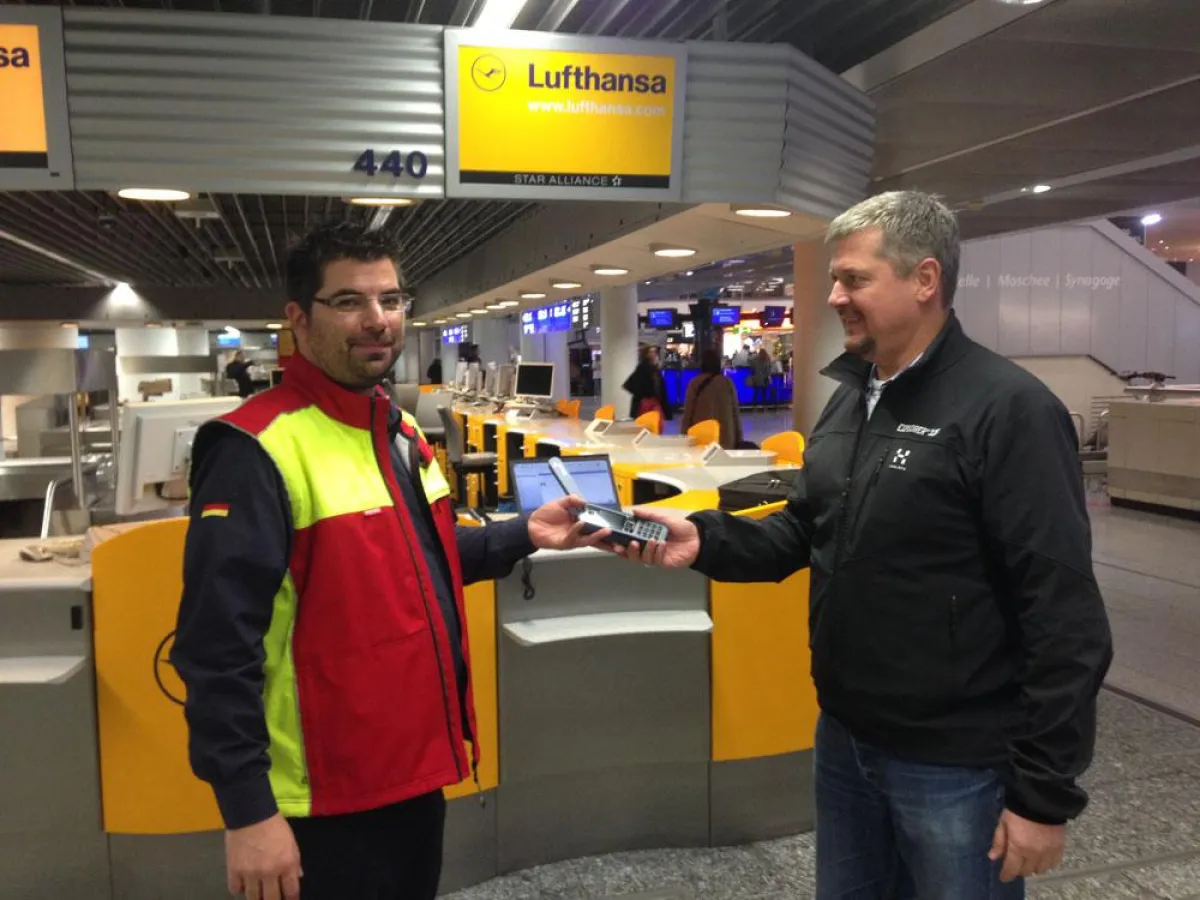 Übergabe des Satellitentelefons am Frankfurter Flughafen