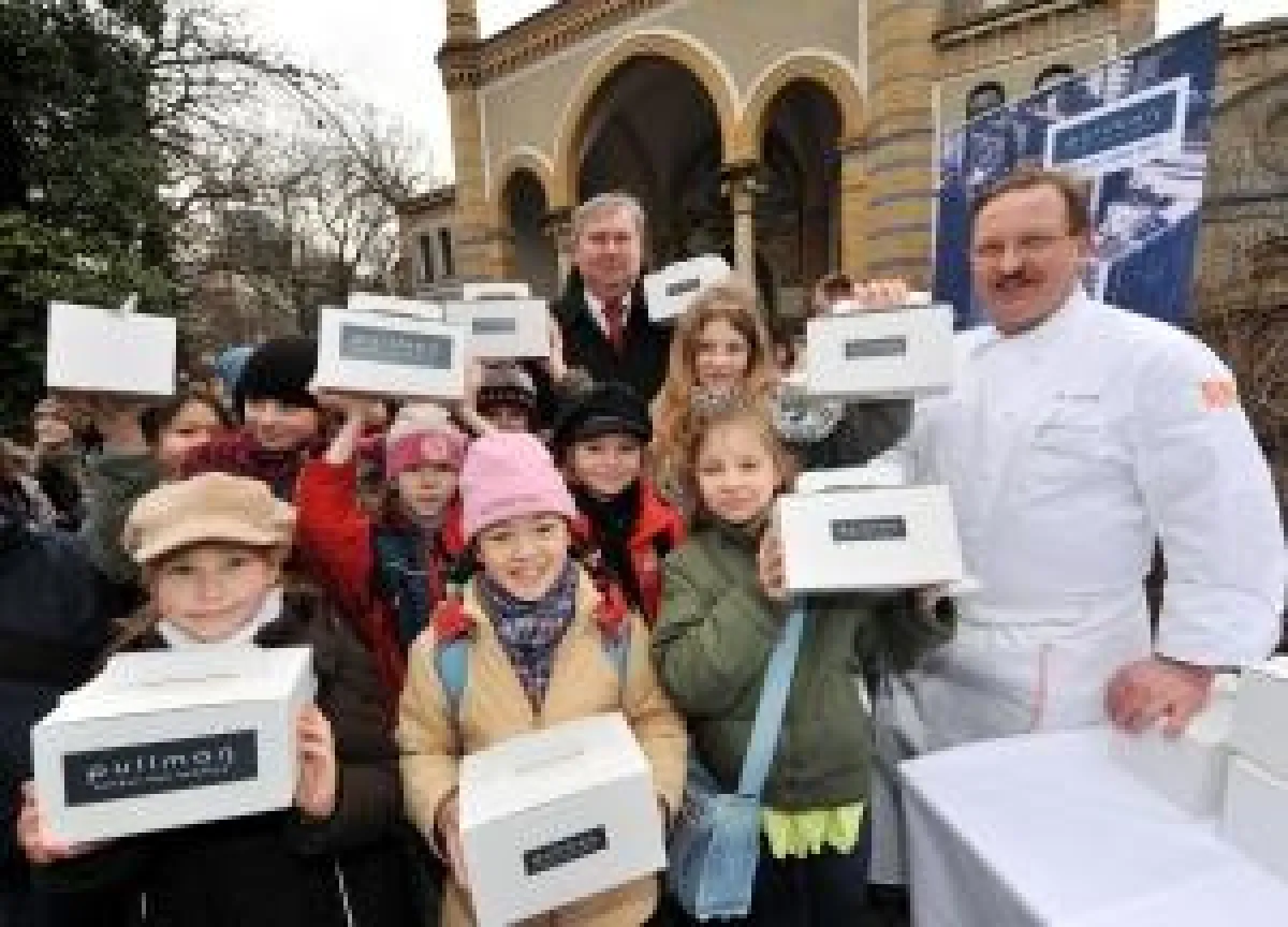 Bernhard Blaskiewitz, der Direktor des Berliner Zoos (im Hintergrund), verteilte gemeinsam mit Küchendirektor Michael Zawaba vom Pullman Berlin Schweizerhof (rechts) gesunde Snacks an die jungen Arten