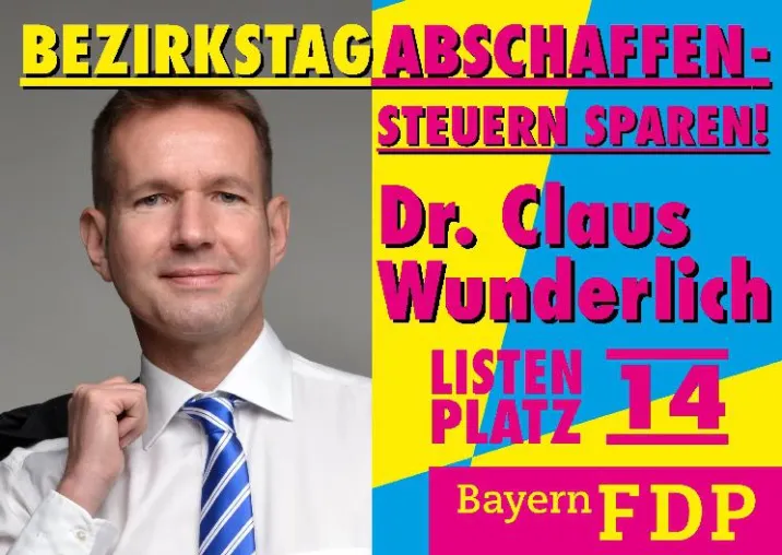Bild: Dr. Claus Wunderlich (FDP) präsentiert sein Plakat zur Bezirkstagswahl